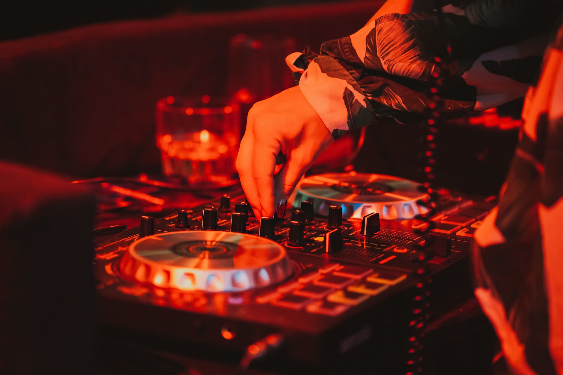 dj mixing music on remote control in nightclub